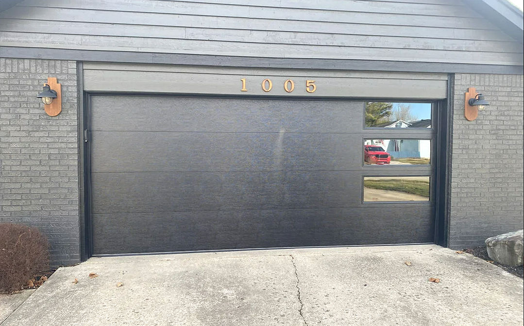 Custom garage door installation in progress by Westerville Garage Door Repair, showcasing high-quality craftsmanship and design tailored to enhance your home’s curb appeal.