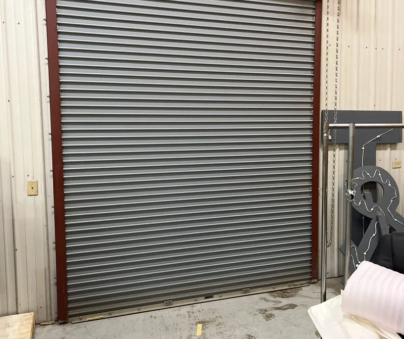 A team of professionals repairing a commercial garage door, highlighting expertise and efficiency in Westerville Garage Door Repair services.