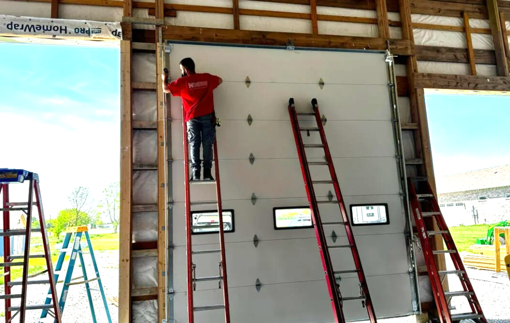 Professional garage door installation in progress at a residential home by Westerville Garage Door Repair, showcasing a technician fitting a high-quality new garage door.