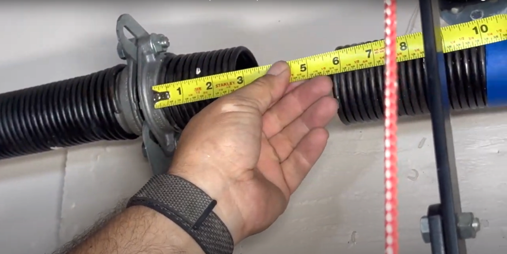 Close-up of a professional technician performing garage door spring repair on a modern residential garage door in Westerville.