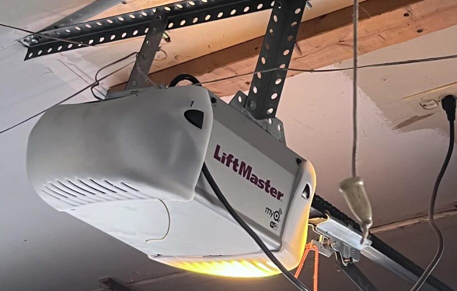 Technician repairing a garage door opener in Westerville, showcasing professional repair service by Westerville Garage Door Repair LLC.