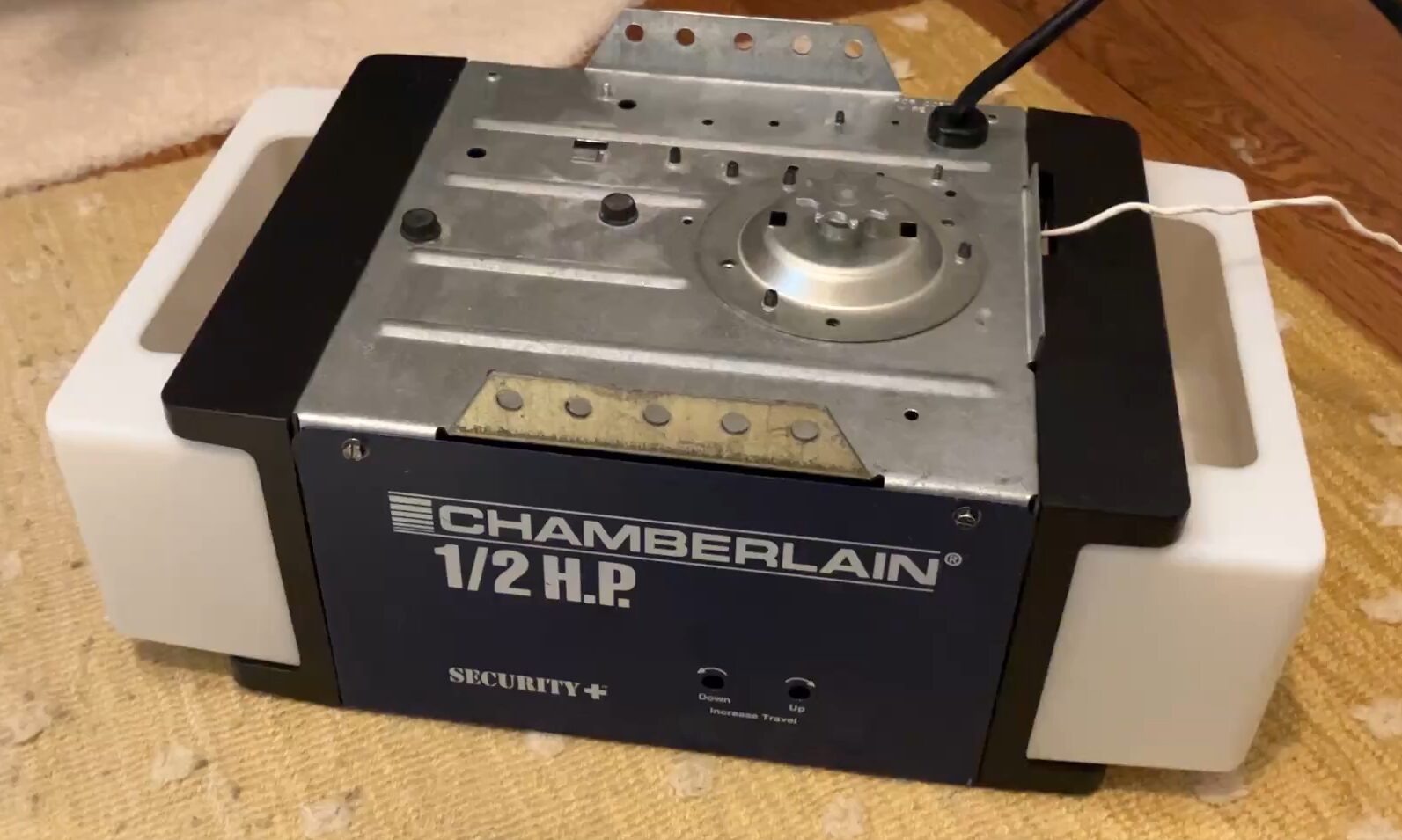 a technician fixing a garage door opener with various tools, representing expert repair services offered by Westerville Garage Door Repair to ensure safety and functionality of garage doors in Westerville, Ohio.