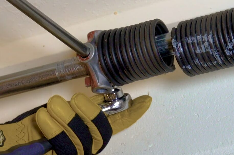 Professional garage door technician replacing a broken garage door spring at Westerville Garage Door Repair